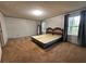 Main bedroom with neutral walls and carpets provides a bright and calm space at 148 Boogers Hill Rd, Oxford, GA 30054