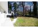 Backyard view showcases a freshly painted white home with a black deck, steps, and a convenient concrete walkway at 1616 W Kellogg Cir, Douglasville, GA 30134