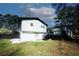 Backyard features a freshly painted home with a large black deck, steps, and a concrete walkway at 1616 W Kellogg Cir, Douglasville, GA 30134