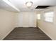 Basement area with multiple doors, new flooring, and two windows at 1616 W Kellogg Cir, Douglasville, GA 30134