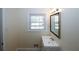 Bathroom featuring a single sink vanity with mirror, and a window at 1616 W Kellogg Cir, Douglasville, GA 30134
