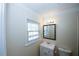 Bathroom featuring a single sink vanity with mirror, toilet, and window at 1616 W Kellogg Cir, Douglasville, GA 30134