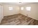 Bedroom featuring wood flooring, a double door closet, and natural light from three windows at 1616 W Kellogg Cir, Douglasville, GA 30134