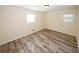 Bedroom with wood flooring and natural light from two windows at 1616 W Kellogg Cir, Douglasville, GA 30134