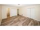 Spacious bedroom with wood flooring and double door closet, adjacent to an ensuite bathroom at 1616 W Kellogg Cir, Douglasville, GA 30134