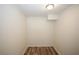 Empty closet with modern laminate flooring, ceiling light and white walls at 1616 W Kellogg Cir, Douglasville, GA 30134