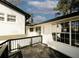 View of freshly painted home with black deck features white siding, many windows, and brick accents at 1616 W Kellogg Cir, Douglasville, GA 30134
