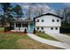 Charming split-level home featuring a blue front door, freshly painted exterior, and well-manicured lawn at 1616 W Kellogg Cir, Douglasville, GA 30134