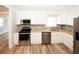 White kitchen features stainless steel appliances and granite countertops at 1616 W Kellogg Cir, Douglasville, GA 30134