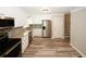 Well-lit kitchen features stainless appliances, white cabinets, and backsplash at 1616 W Kellogg Cir, Douglasville, GA 30134