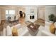 Bright and airy living room with hardwood floors, a fireplace, and open layout to the dining area at 1616 W Kellogg Cir, Douglasville, GA 30134