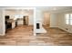 Open-concept living room with hardwood floors, fireplace, and adjacent kitchen with stainless appliances at 1616 W Kellogg Cir, Douglasville, GA 30134