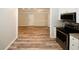 View from the kitchen into the living room with wood floors and lots of light at 1616 W Kellogg Cir, Douglasville, GA 30134