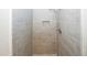 The updated shower features custom tile work and recessed storage at 1616 W Kellogg Cir, Douglasville, GA 30134
