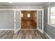 Spacious sunroom with hardwood floors, brick accent wall, and French door access to another room at 1616 W Kellogg Cir, Douglasville, GA 30134