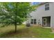 Small backyard features an air conditioner, a small tree, and a well maintained lawn at 3565 Brycewood Dr, Decatur, GA 30034
