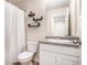 A well-lit bathroom with white vanity, framed mirror, decor shelves, and a shower/tub with curtain rod at 3565 Brycewood Dr, Decatur, GA 30034