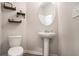 Charming powder room with pedestal sink, decorative shelves, and stylish oval mirror at 3565 Brycewood Dr, Decatur, GA 30034