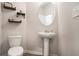 Powder room with pedestal sink, decorative shelves, and stylish fixtures at 3565 Brycewood Dr, Decatur, GA 30034