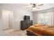 Comfortable bedroom featuring a ceiling fan, TV, and a plush bed with side access to the closet at 3565 Brycewood Dr, Decatur, GA 30034