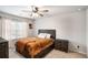 Cozy bedroom featuring a ceiling fan, bedside table and a plush bed with storage at 3565 Brycewood Dr, Decatur, GA 30034