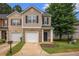 Inviting townhome with a well-manicured lawn, brick accents and a one-car garage at 3565 Brycewood Dr, Decatur, GA 30034