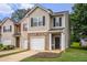 Charming townhome featuring a brick facade, black shutters, and an attached garage at 3565 Brycewood Dr, Decatur, GA 30034