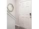 Entryway with a modern mirror and a white door, complemented by sleek gray floors at 3565 Brycewood Dr, Decatur, GA 30034