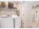 Well-organized laundry room with washer, dryer, and shelving for storage at 3565 Brycewood Dr, Decatur, GA 30034