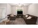 Cozy living room featuring plush seating, a fireplace, and ample natural light at 3565 Brycewood Dr, Decatur, GA 30034