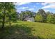 Backyard with a large yard and a view of the rear of the home and tree line at 3919 Mccullers Rd, Loganville, GA 30052