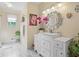 Bathroom with a large sink vanity, a decorative mirror, and stylish marble floors at 3919 Mccullers Rd, Loganville, GA 30052