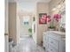 Bright bathroom with a large mirror, a combination tub/shower, and marble floors at 3919 Mccullers Rd, Loganville, GA 30052
