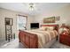 Bedroom with a wood framed bed and decor, a ceiling fan, and neutral colored walls at 3919 Mccullers Rd, Loganville, GA 30052