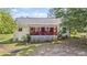 Charming home with a lovely red-railed front porch perfect for enjoying the outdoors at 3919 Mccullers Rd, Loganville, GA 30052