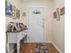 Foyer featuring wood-look floors, a decorative hall table, and framed Gathering photos at 3919 Mccullers Rd, Loganville, GA 30052