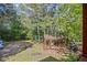 Outdoor gazebo with seating area, nestled amongst mature trees for a private retreat at 3919 Mccullers Rd, Loganville, GA 30052