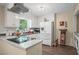 Bright kitchen with white cabinets, granite countertops, stainless appliances, and wood-look floors at 3919 Mccullers Rd, Loganville, GA 30052
