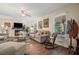 Comfortable living room featuring a fireplace, wood floors, neutral furniture and natural light at 3919 Mccullers Rd, Loganville, GA 30052