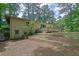 Brick home with a wooden deck and landscaped backyard at 4420 Lake Breeze Dr, Stone Mountain, GA 30083