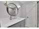 Bathroom features a vanity with a round mirror and modern sconces at 4420 Lake Breeze Dr, Stone Mountain, GA 30083