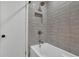 Shower with gray tiled walls, shower head, and soap niche at 4420 Lake Breeze Dr, Stone Mountain, GA 30083