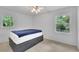 Bedroom with hardwood floors, a window, and modern ceiling fan at 4420 Lake Breeze Dr, Stone Mountain, GA 30083