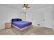 Bedroom with two windows, overhead fan, and hardwood flooring at 4420 Lake Breeze Dr, Stone Mountain, GA 30083