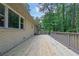 Large wooden deck extends across the back of the brick home at 4420 Lake Breeze Dr, Stone Mountain, GA 30083