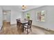Traditional dining room with wainscoting and hardwood floors plus outdoor view at 4420 Lake Breeze Dr, Stone Mountain, GA 30083