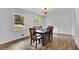 Well lit dining room with a large window offering bright sunlight and hardwood flooring at 4420 Lake Breeze Dr, Stone Mountain, GA 30083