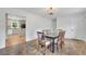 Bright dining room with hardwood floors and a chandelier, plus a partial view into the kitchen at 4420 Lake Breeze Dr, Stone Mountain, GA 30083