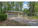 Ranch-style brick home featuring a two-car garage and mature landscaping at 4420 Lake Breeze Dr, Stone Mountain, GA 30083