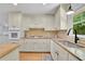 Bright kitchen with white cabinets, granite countertops, and a window view at 4420 Lake Breeze Dr, Stone Mountain, GA 30083
